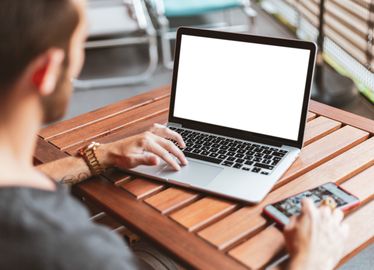 Ragazzo di spalle che lavora al laptop